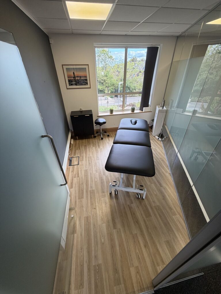 Massage therapy bed in the wellness room at The Better YOU Project
